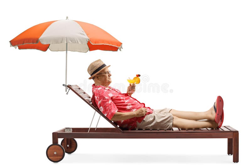 Mature male tourist holding a cocktail and relaxing under umbrella stock photo Mature male tourist holding a cocktail and relaxing under umbrella stock photo