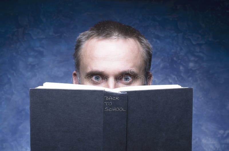 Mature man being focused and hooked by book, reading open book, surprised young man, amazing eyes looking blank cover, back to sch stock images Mature man being focused and hooked by book, reading open book, surprised young man, amazing eyes looking blank cover, back to sch stock images