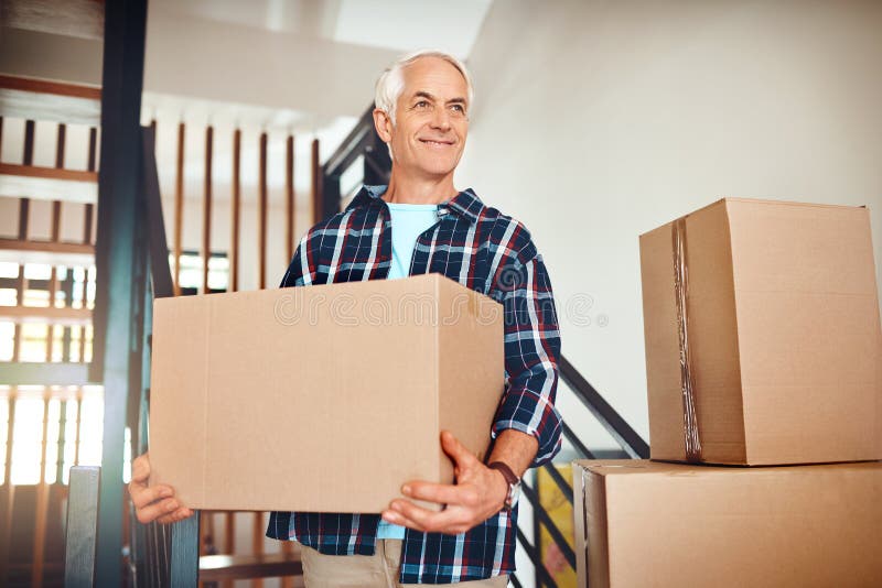Mature man, boxes and moving into new home with smile, vision or idea for decor, renovation or real estate investment royalty free stock photography