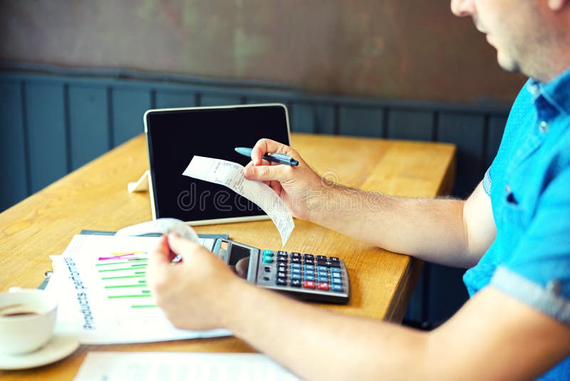 Mature man calculating bills and taxes of small business stock images Mature man calculating bills and taxes of small business stock images