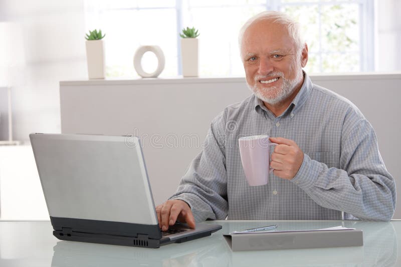 Mature man with computer smiling