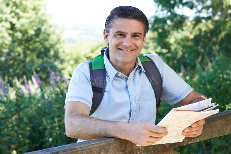 An Old Man From The Countryside Portrait of Mature Man Hiking in Countryside Looking at Map Stock Image