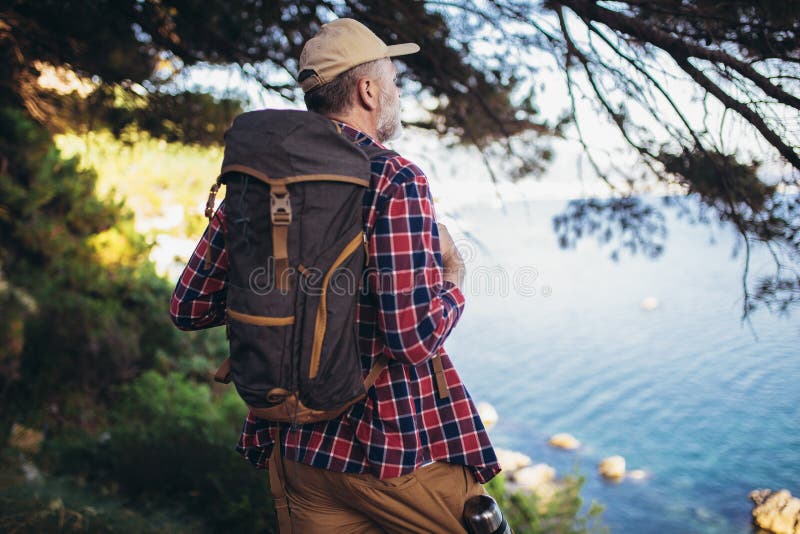 Man, hiking by the sea and exploring the nature royalty free stock photography