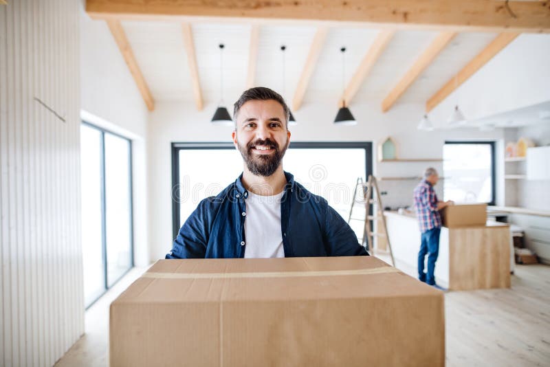 A mature man with his senior father furnishing new house, a new home concept. royalty free stock images A mature man with his senior father furnishing new house, a new home concept. royalty free stock images