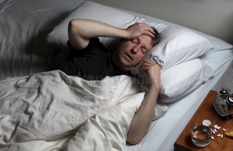 Mature man in physical pain while trying to fall asleep royalty free stock photos Mature man in physical pain while trying to fall asleep royalty free stock photos