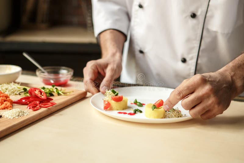 Mature man professional chef cooking meal indoors stock photo Mature man professional chef cooking meal indoors stock photo