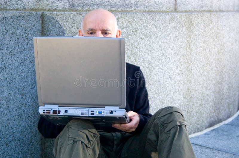 Mature man using a computer royalty free stock photography Mature man using a computer royalty free stock photography