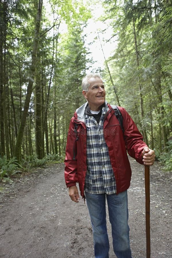 Mature Man Walking On Forest Path