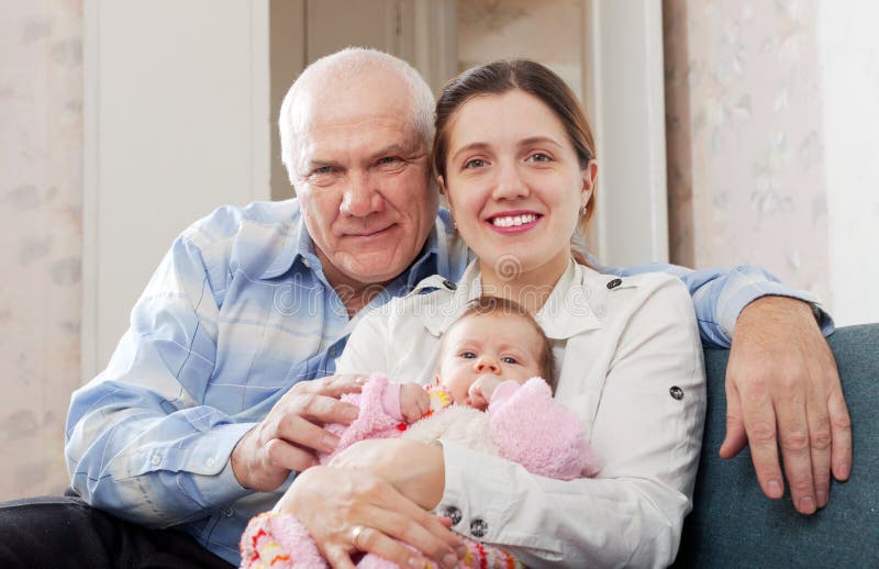 Mature man and young woman with baby stock photo Mature man and young woman with baby stock photo