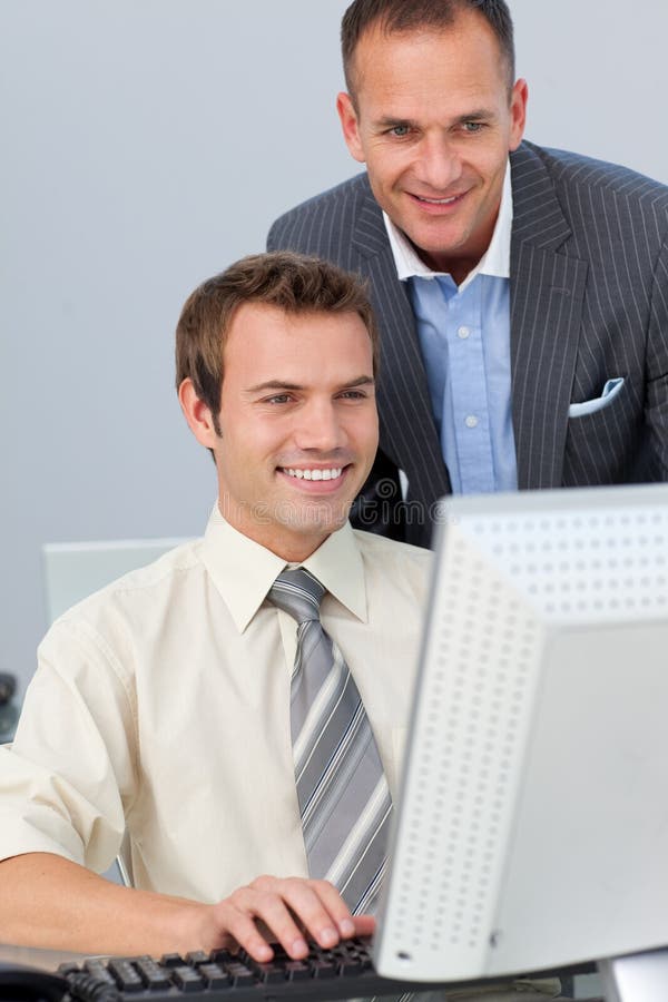 Mature manager checking his employee's work stock photos