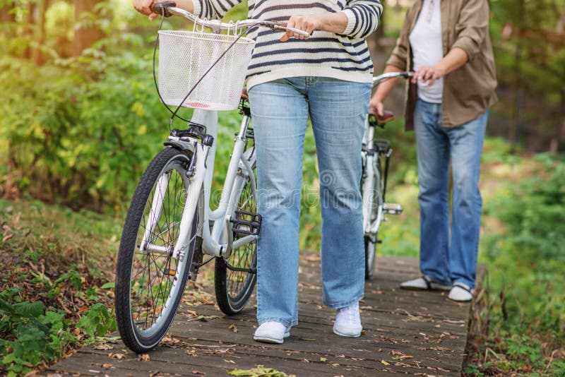Mature married couple walking with bicycles royalty free stock photo Mature married couple walking with bicycles royalty free stock photo