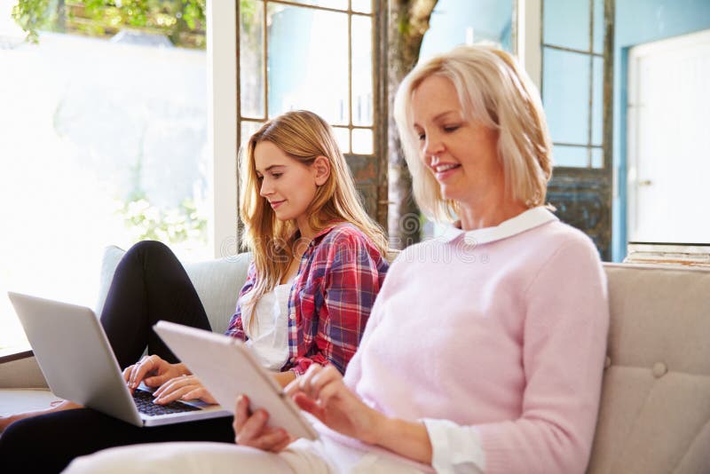 Mature Mother With Adult Daughter Using Digital Devices royalty free stock photo Mature Mother With Adult Daughter Using Digital Devices royalty free stock photo