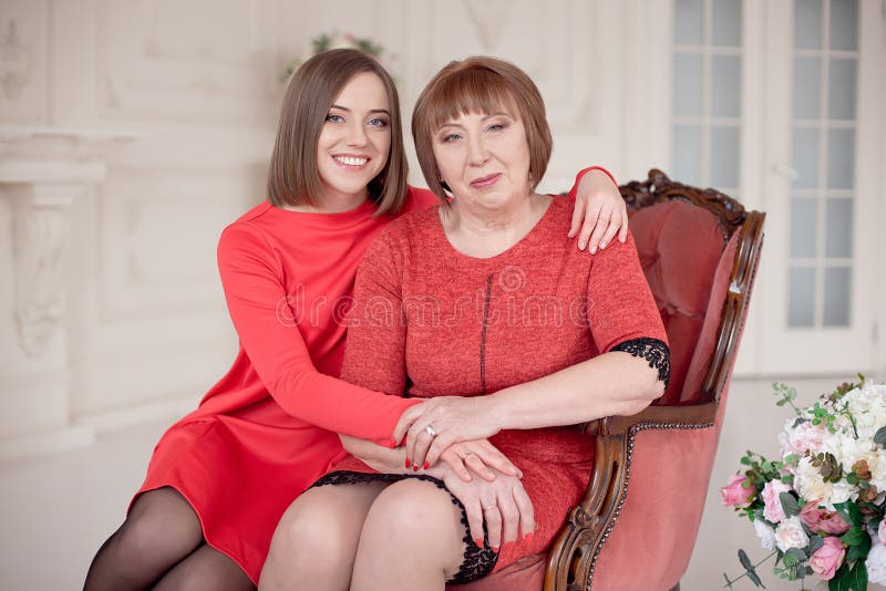 Mature Mother Hugging With Her Teen Daughter Outdoor In Nature On Sunny Day