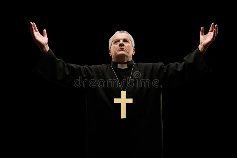 Mature priest praying to god isolated on black background