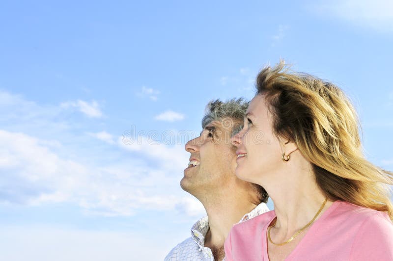 Mature romantic couple of baby boomers looking at the sky