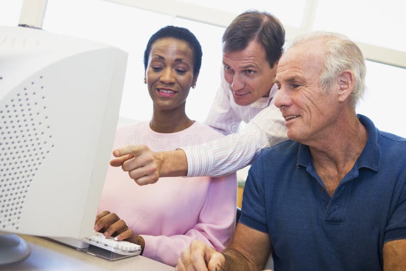 Mature students learning computer skills stock photo Mature students learning computer skills stock photo