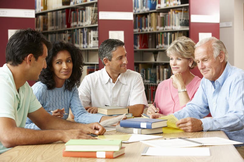 Mature students working in library stock images Mature students working in library stock images