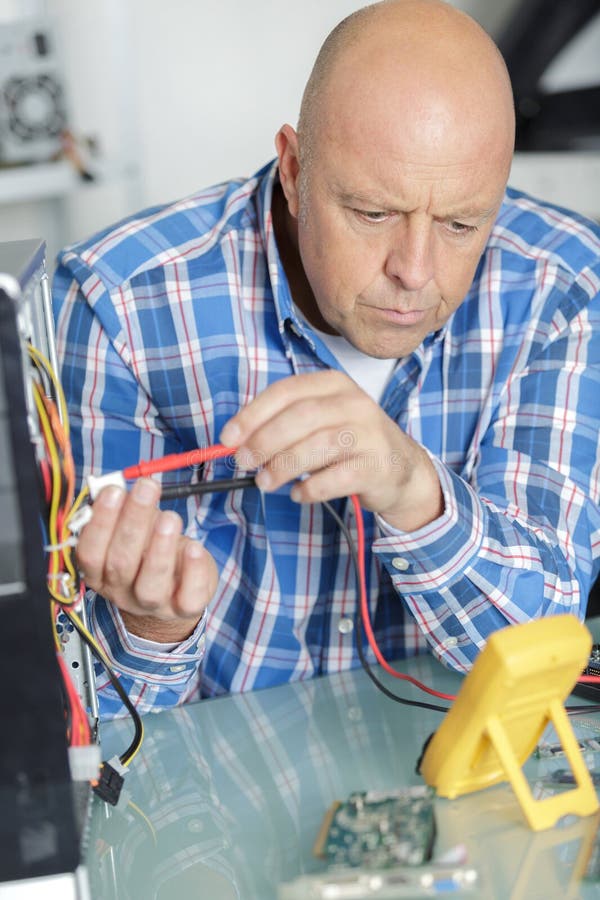 Mature Technician Using Voltage Meter Stock Image Image of expert
