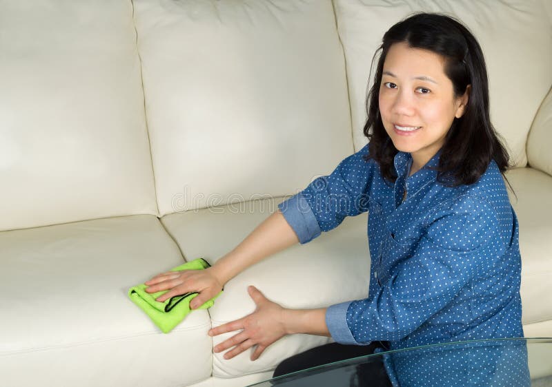 Mature woman cleaning Sofa with Microfiber Rag royalty free stock photos Mature woman cleaning Sofa with Microfiber Rag royalty free stock photos