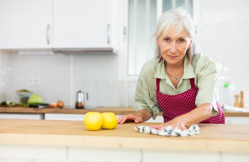 Mature Woman Cleaning Kitchen Table At Home Stock Image Image Of 