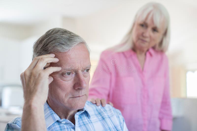 Mature Woman Comforting Man With Depression At Home