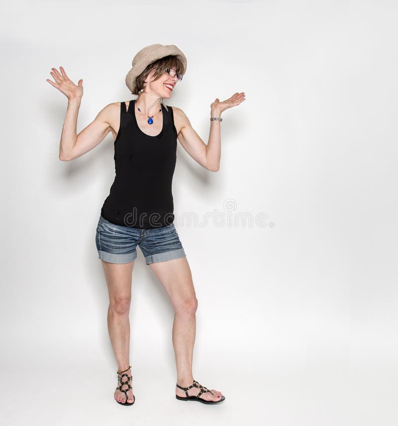 Mature Woman in Hat and Jean Shorts Shrugging Shoulders Stock Image - Image  of attractive, beautiful: 153519271