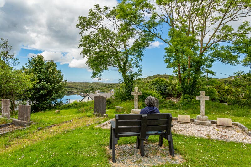 Mature woman sitting relaxed on a bench with her back to the camera royalty free stock photos Mature woman sitting relaxed on a bench with her back to the camera royalty free stock photos