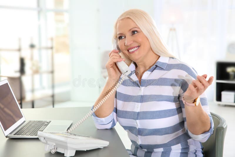 Mature woman talking on phone royalty free stock photo