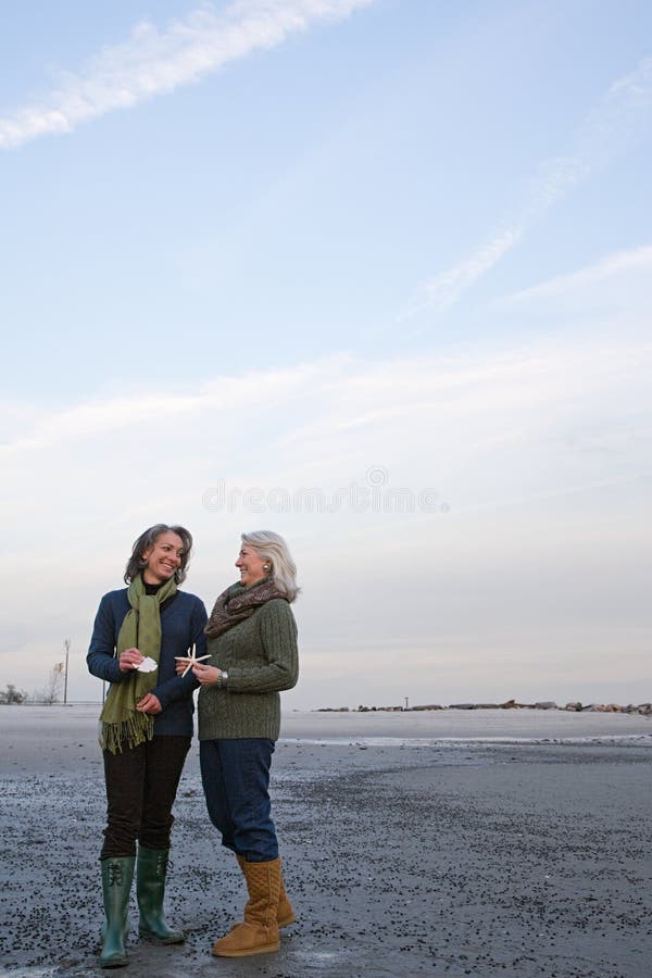 Mature Women Standing on a Beach Stock Photo - Image of golden, people ...