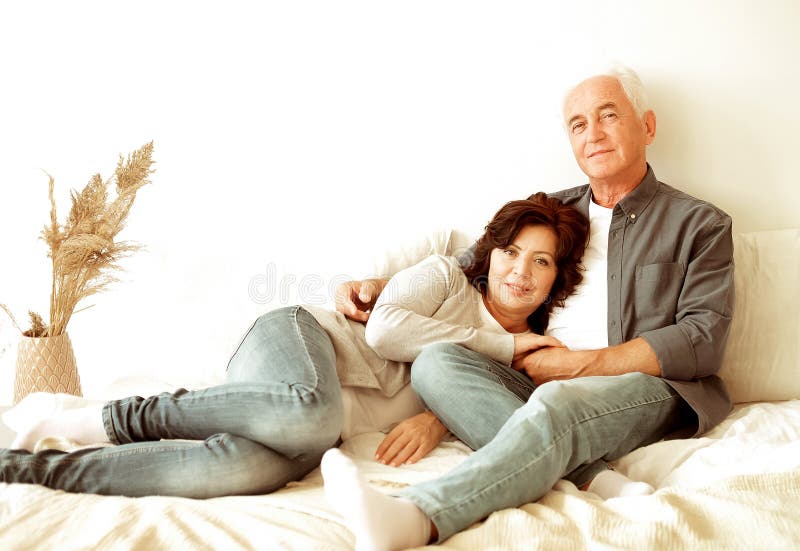 Mature 60 Year Old Couple Hugging While Laying On The Bed In The Bedroom Stock Image Image Of 