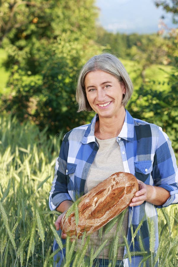 Matured farm woman with freshly baked bread