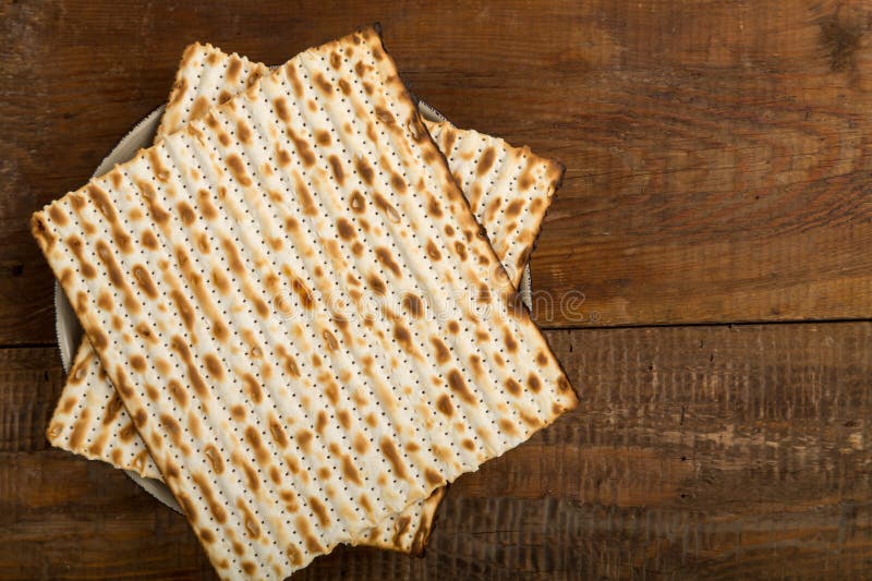 Matzah on a Plate on a Wooden Table Laid Out in the Form of Magen David