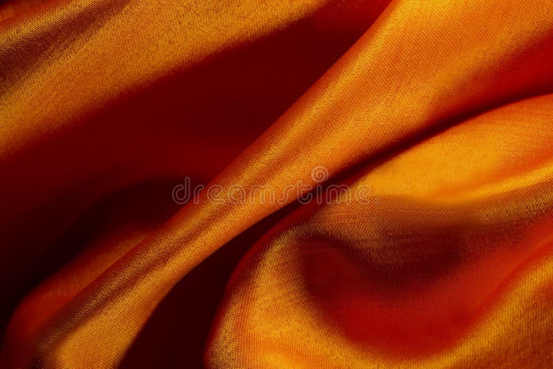 Matériel en soie de satin de texture de tissu de luxe orange abstrait de fond ou fin luxueuse images libres de droits Matériel en soie de satin de texture de tissu de luxe orange abstrait de fond ou fin luxueuse images libres de droits