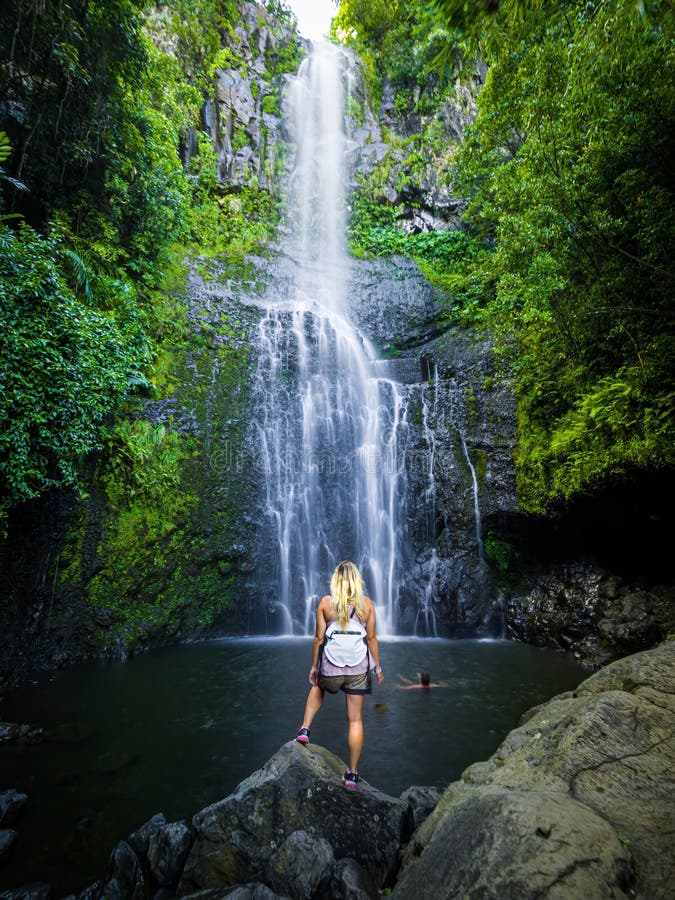 Maui, Hawaii Hana Highway, Sexy blonde girl admires Wailua Falls, near Lihue, Kauai. Road to Hana connects Kahului to the town of Hana Over 59 bridges, 620 curves, tropical rainforest. Maui, Hawaii Hana Highway, Sexy blonde girl admires Wailua Falls, near Lihue, Kauai. Road to Hana connects Kahului to the town of Hana Over 59 bridges, 620 curves, tropical rainforest.