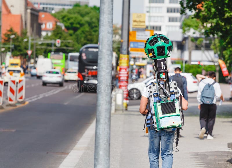 Young man from google corporation is working with huge backpack with 3D panoramic camera used for royalty free stock photos