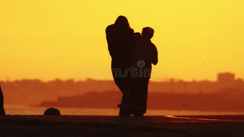 24 may 2023, Costa da Caparica, Portugal: silhouettes of a woman on skateboard at bright sunset