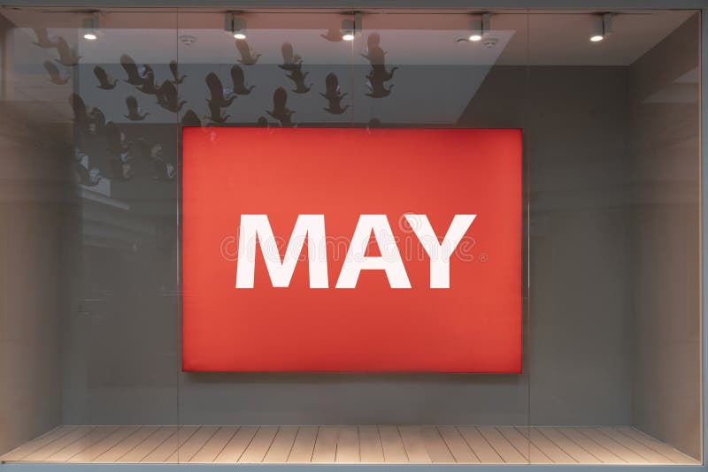 May is the name of the month in white letters on a red billboard billboard in the store. the onset of spring royalty free stock images