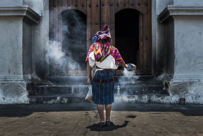 Mayan woman performing a ritual in front of the Santo TomÃ¡s church in the town of Chichicastenango, in Guatemala
