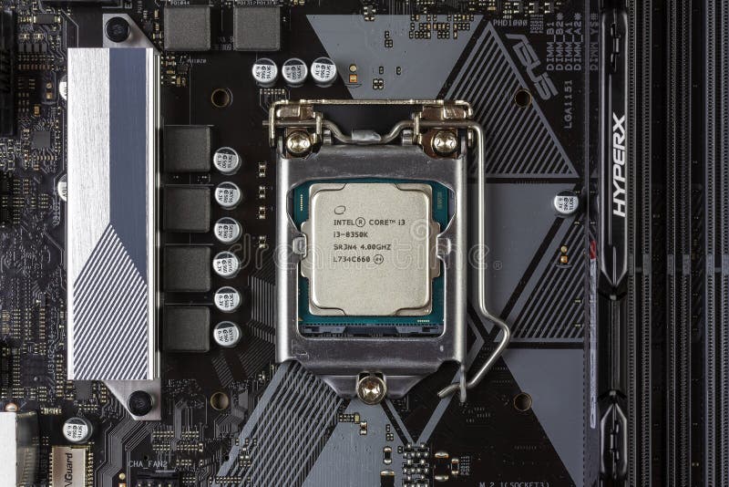 Intel core I3 desktop processor 8th gen and black DDR 4 DIMM 16 Gb Kingston HyperX Fury Memory RAM Module in the slot on the mothe stock image Intel core I3 desktop processor 8th gen and black DDR 4 DIMM 16 Gb Kingston HyperX Fury Memory RAM Module in the slot on the mothe stock image