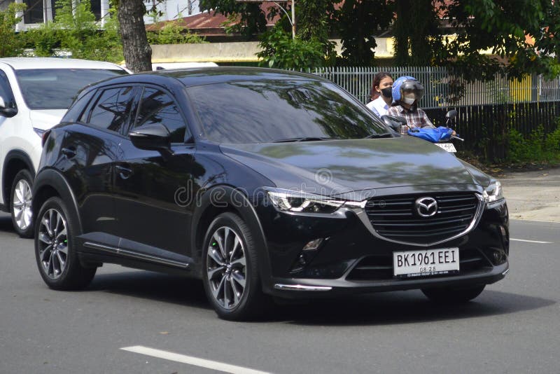 A black hatchback Mazda CX-3 2023 on the street in Medan, North Sumatra, Indonesia &#x28;February 20, 2024&#x29;. A black hatchback Mazda CX-3 2023 on the street in Medan, North Sumatra, Indonesia &#x28;February 20, 2024&#x29;.