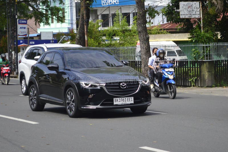 A black hatchback Mazda CX-3 2023 on the street in Medan, North Sumatra, Indonesia &#x28;February 20, 2024&#x29;. A black hatchback Mazda CX-3 2023 on the street in Medan, North Sumatra, Indonesia &#x28;February 20, 2024&#x29;.