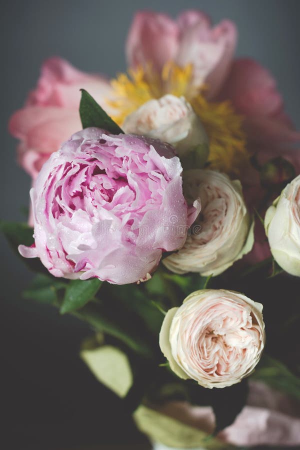 Peonies and roses bouquet. Shabby chic pastel colored wedding bouquet. Closeup view, selective focus. Peonies and roses bouquet. Shabby chic pastel colored wedding bouquet. Closeup view, selective focus