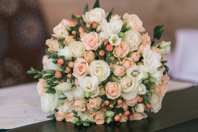 Wedding bouquet of small white and pastel pink roses and berries. Wedding bouquet of small white and pastel pink roses and berries