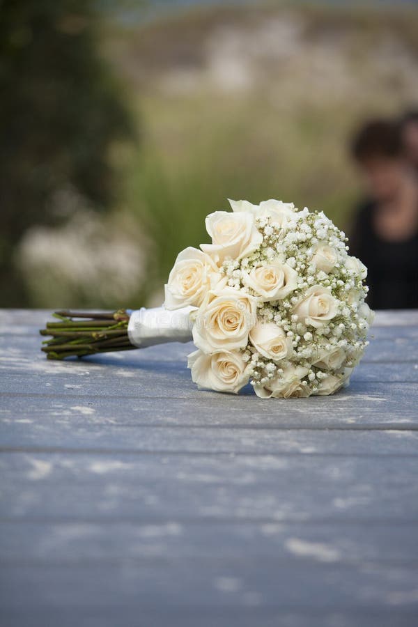 Bouquet of roses for wedding on sandy boardwalk for beach wedding. Bouquet of roses for wedding on sandy boardwalk for beach wedding