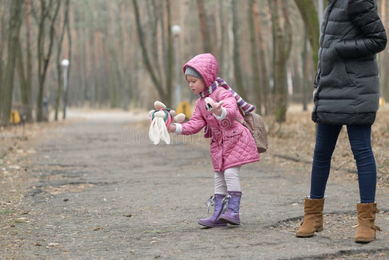 Little girl dropped the doll on a walk. Little girl dropped the doll on a walk.