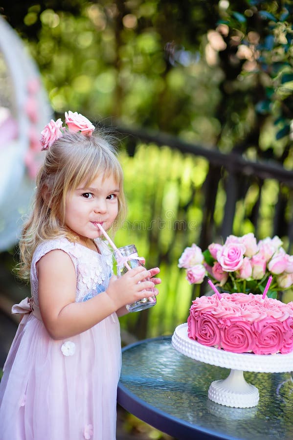 Little girl celebrate Happy Birthday Party with rose decor in the beautiful garden. Little girl celebrate Happy Birthday Party with rose decor in the beautiful garden