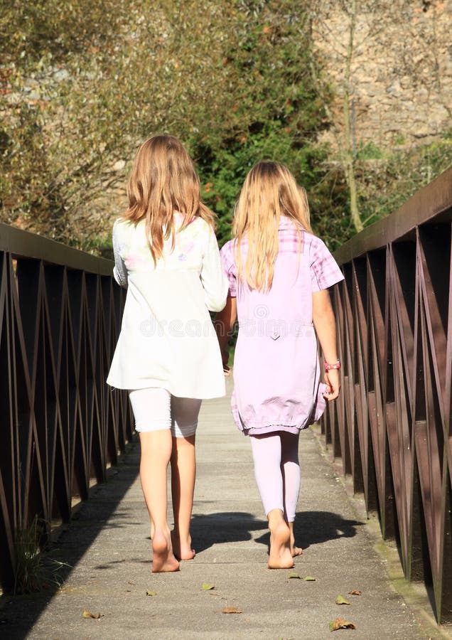 Barefoot girls - kids walking on bridge. Barefoot girls - kids walking on bridge