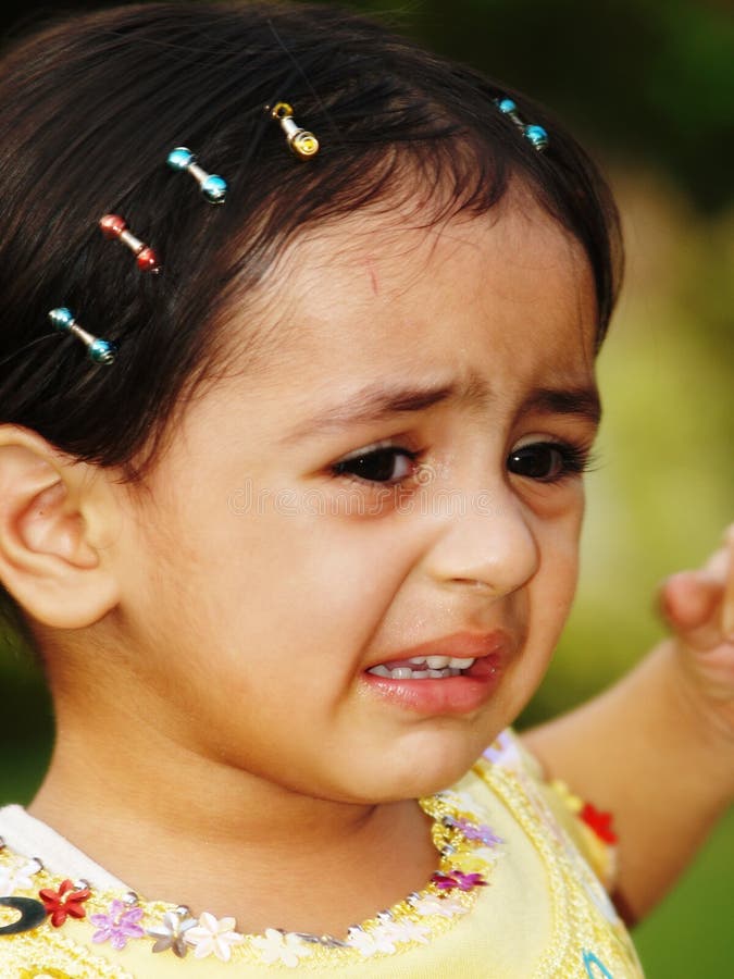 A portrait of a cute but unhappy little Asian girl crying. A portrait of a cute but unhappy little Asian girl crying.