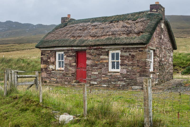Achill Island, Ireland- Jul 31, 2020: A small traditional Irish thatched cottage. Achill Island, Ireland- Jul 31, 2020: A small traditional Irish thatched cottage
