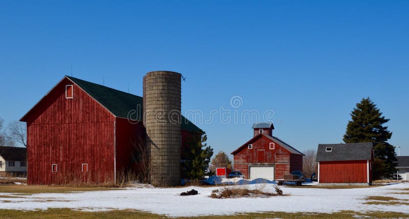 This is a Winter picture of a small family corn farm outside of Plainfield, Illinois. This picture features a barn, silo, corn crib, and an outbuilding. This picture was taken on March 11, 2015. This is a Winter picture of a small family corn farm outside of Plainfield, Illinois. This picture features a barn, silo, corn crib, and an outbuilding. This picture was taken on March 11, 2015.